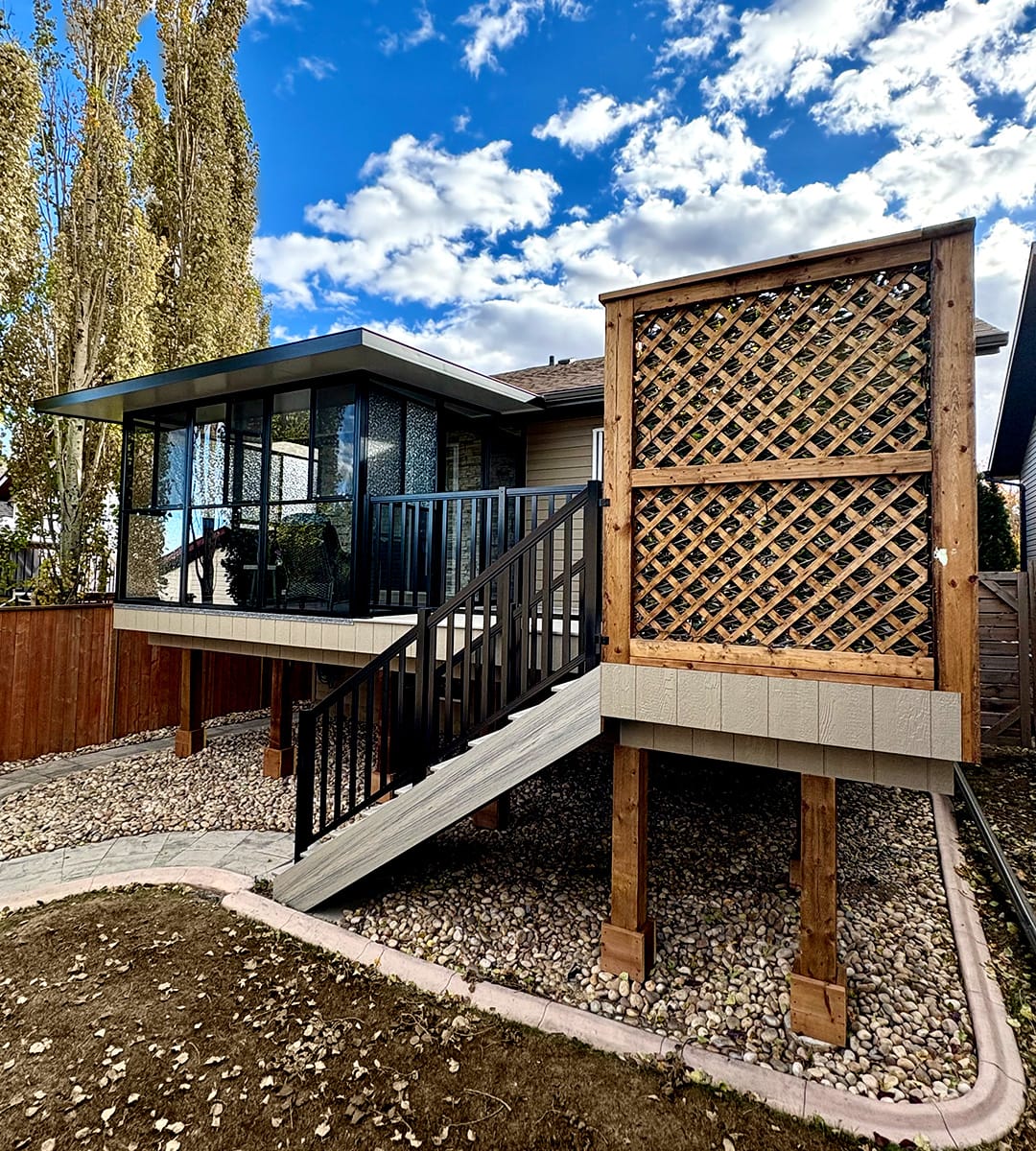 Beautiful deck with glass sun room and wooden privacy wall